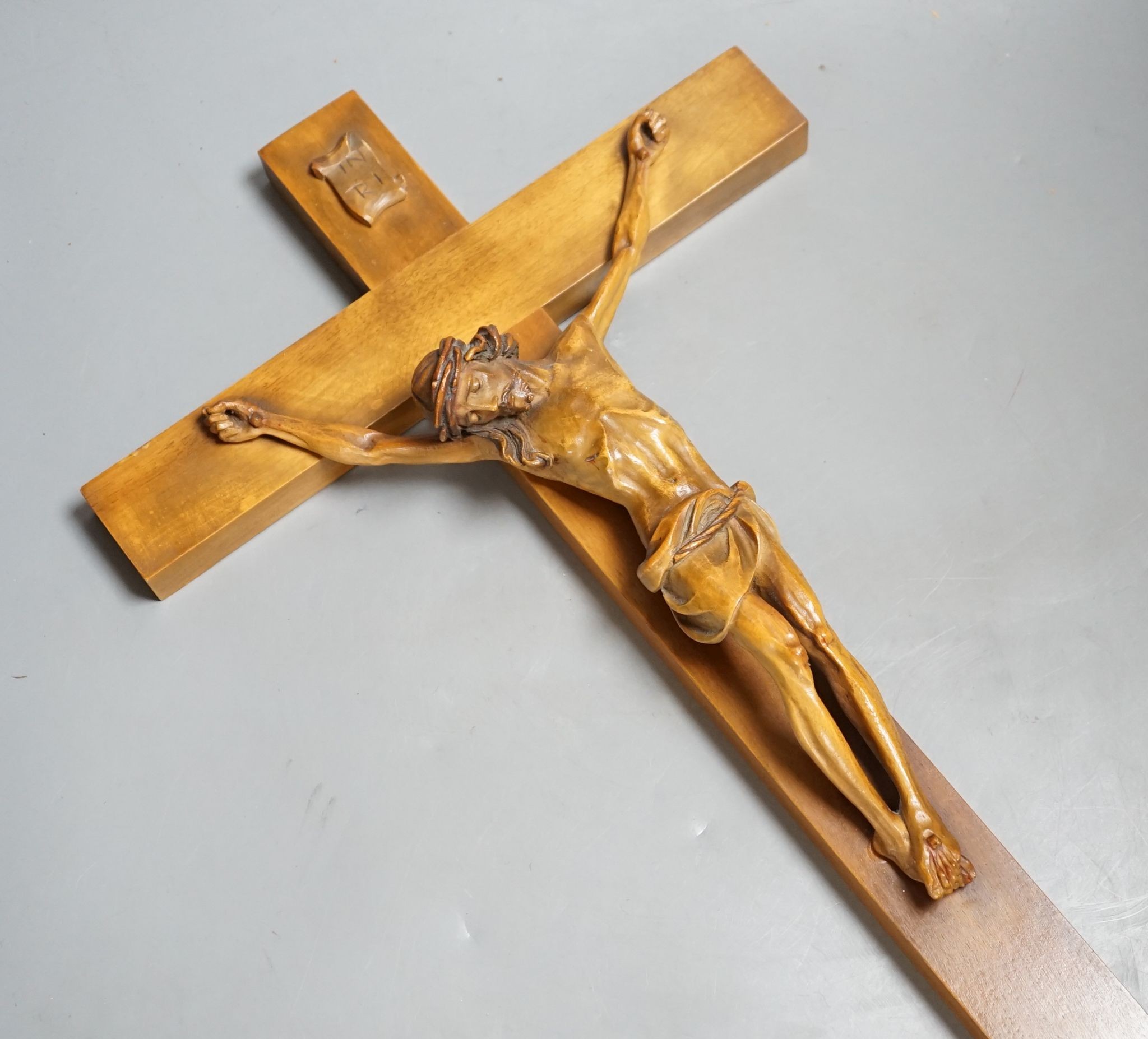 A carved crucifix and a framed metal Peruvian colonial crucifix, 50cm